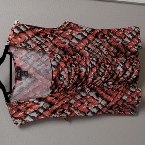 Geometric shell blouse with cut off sleeve.